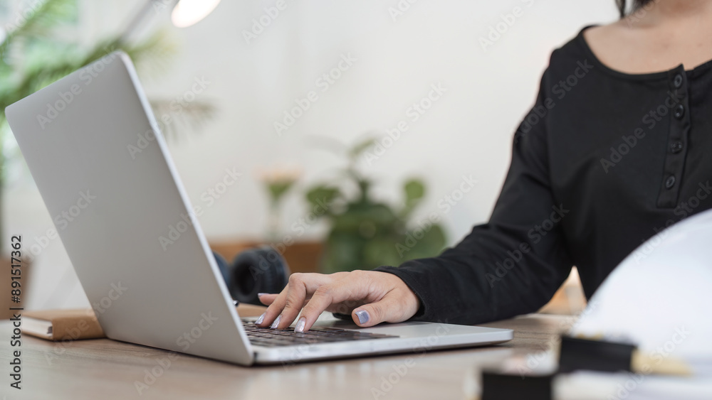Young Accountant Working on Financial Documents at Home Using Laptop in Modern Home Office Setting Young Accountant Working on Financial Documents at Home Using Laptop in Modern Home Office Setting
