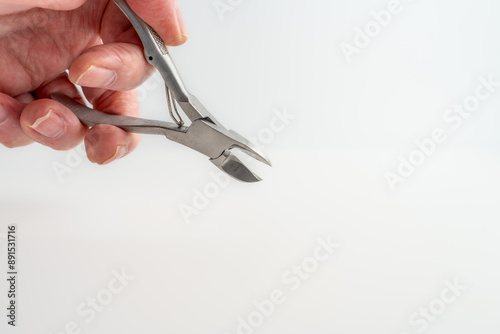 person holding using a pair of stainless steel precision sharp point nose plier cutters photo