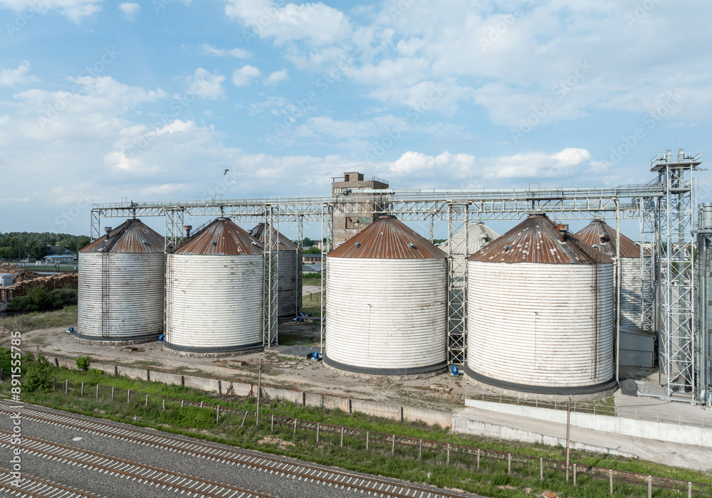 Agro-processing manufacturing plant for processing drying cleaning and storage of agricultural product, grain harvest. Modern silos. grain elevator facility. Large iron terminal of grain Agro-processing manufacturing plant for processing drying cleaning and storage of agricultural product, grain harvest. Modern silos. grain elevator facility. Large iron terminal of grain