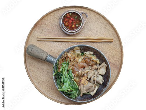 Stir-fried Wide Rice Noodles in Sweet Soy Sauce with Pork and Chinese kale(Pad See-Ew)served with chopsticks and Thai chilli fish sauce on Woonden tray isolated on white background with clipping path. photo