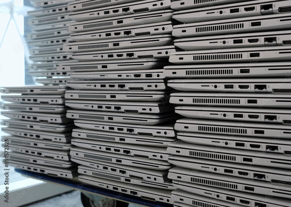 Big stacks of discarded laptops, notebooks on a trolley Big stacks of discarded laptops, notebooks on a trolley