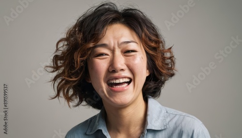 laughing asian woman, portrait of an adult female screaming