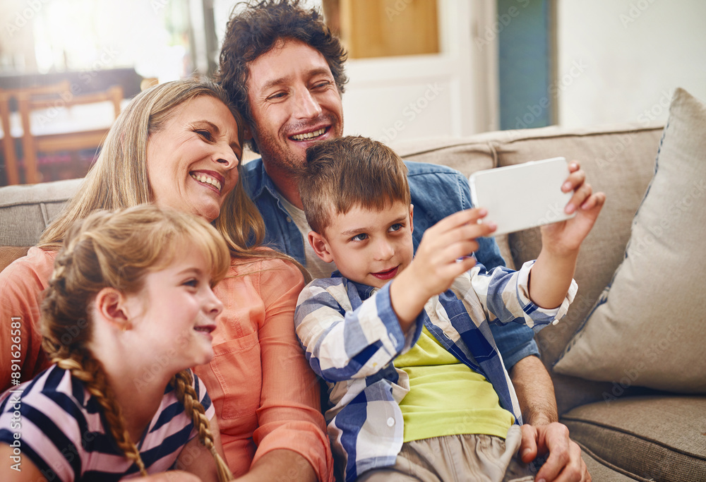 Obraz premium Happy family, relax and sofa with selfie for picture, photography or memory together at home. Mother, father and young children with smile for bonding, holiday or weekend moment on couch at house