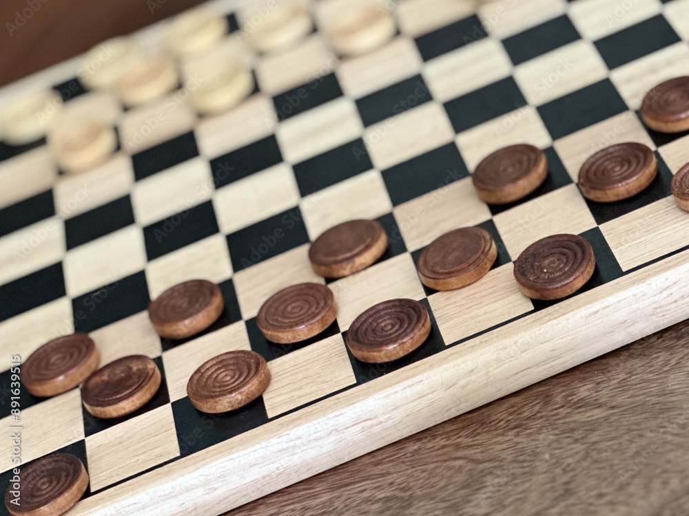 wooden checkers on a wooden chessboard