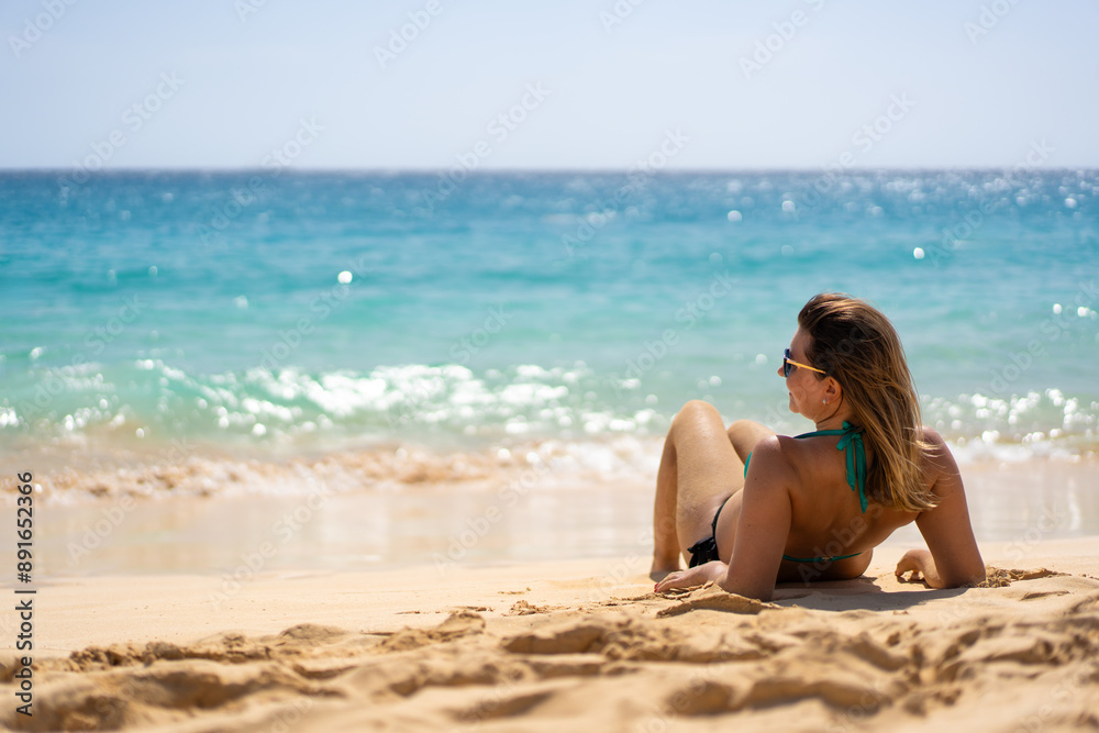 Beach vacation. Happy young woman in bikini lying down on sandy beach by the sea on beautiful sunny day. Positive emotion
Beach vacation. Happy young woman in bikini lying down on sandy beach by the sea on beautiful sunny day. Positive emotion