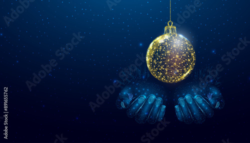 Two hands are holding a Christmas ball. Wireframe glowing low poly design on a blue background. Abstract futuristic vector illustration