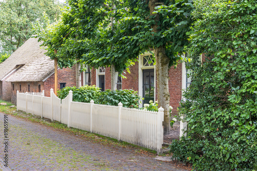 Ancient little farm houses with straw roofing in village Norg in Municipality Noordenveld in the Netherlands. Traditional Esdorp in Northern Drenthe. photo