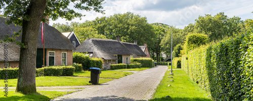 Ancient little farm houses with straw roofing in village Norg in Municipality Noordenveld in the Netherlands. Traditional Esdorp in Northern Drenthe. photo
