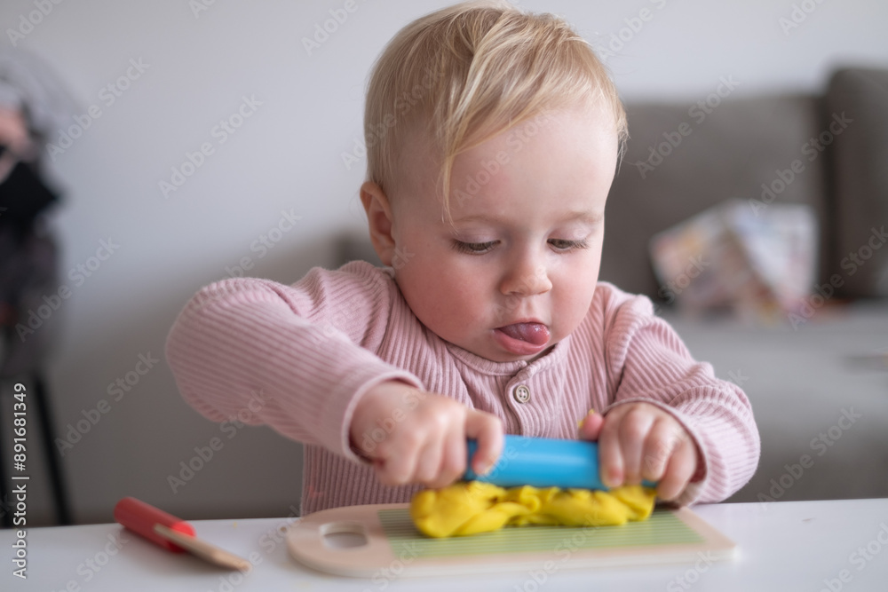 smiling little toddler working with plasticine in art and craft smiling little toddler working with plasticine in art and craft