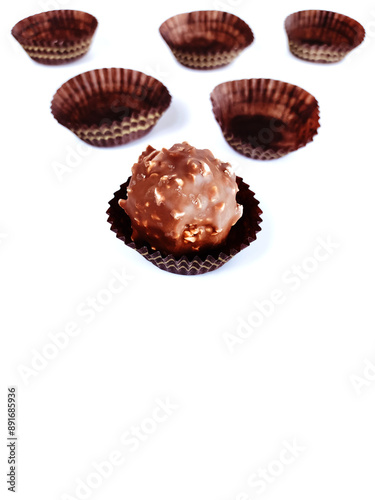 Traditional Brazilian sweet known as brigadeiro or Brazilian truffle and some empty packaging on background with copy space 