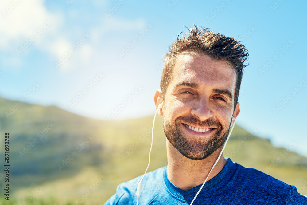 Nature, running and portrait of man with earphones for music, fitness and outdoor exercise. Happy, face and runner on hill listening podcast with confidence, blue sky and morning workout challenge Nature, running and portrait of man with earphones for music, fitness and outdoor exercise. Happy, face and runner on hill listening podcast with confidence, blue sky and morning workout challenge