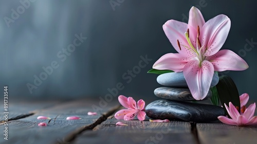 Pink Lily and Stacked Stones on Wooden Surface