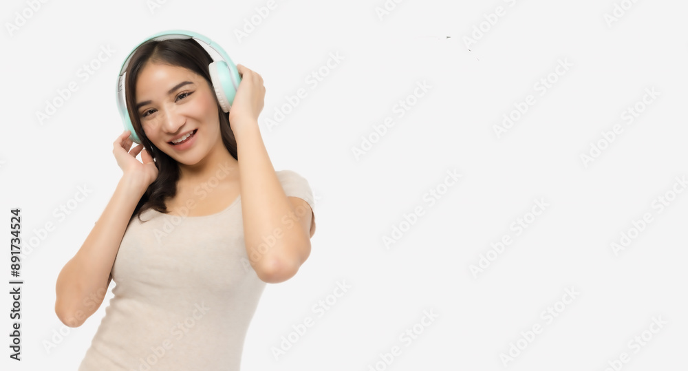Asian cheerful young woman enjoying music with headphones, showcasing a sense of happiness and relaxation against a white background. Asian cheerful young woman enjoying music with headphones, showcasing a sense of happiness and relaxation against a white background.