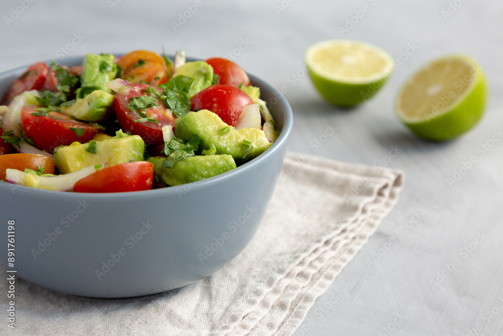 Homemade Avocado And Tomato Salad in a Bowl, side view. Homemade Avocado And Tomato Salad in a Bowl, side view.