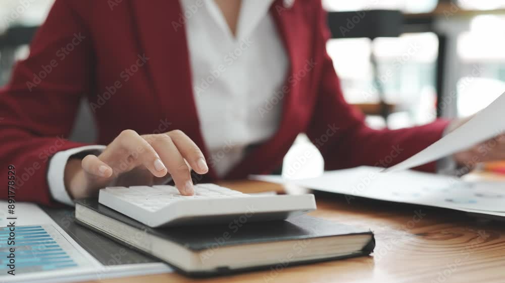 Accountant working on desk using calculator to calculate financial report in office business accounting finance concept
