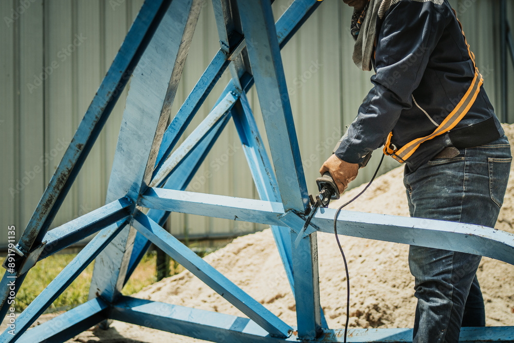 worker to cutting steel in construction site with Reciprocating saw or recip saw, saw used in construction and demolition work without creating any sparks.
