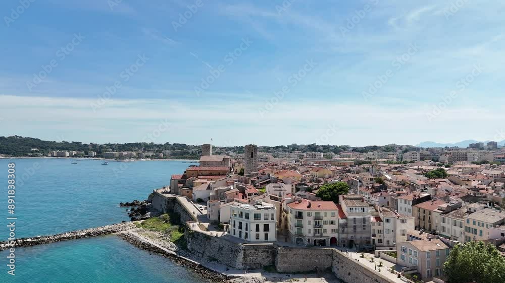 Drone shot of Antibes, France, highlighting the beach, historic church, and the stunning Côte d'Azur coastline along the Mediterranean Sea. Drone shot of Antibes, France, highlighting the beach, historic church, and the stunning Côte d'Azur coastline along the Mediterranean Sea.