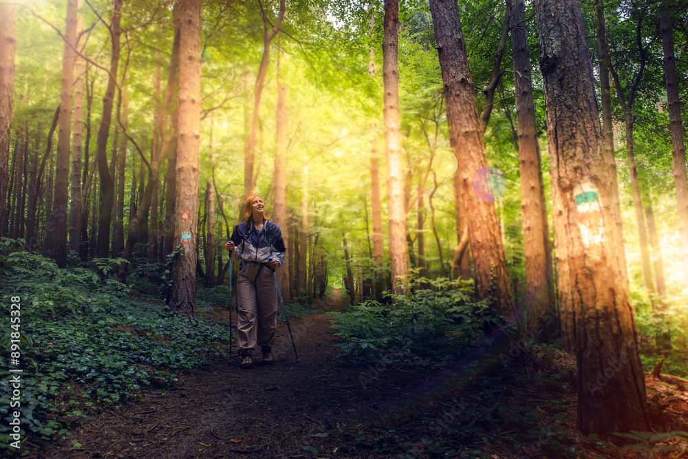 Obraz premium Beautiful young women with big backpack hiking in the deep forest