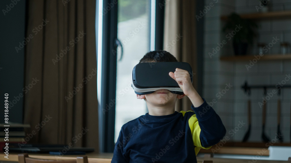 Young boy immersed in a virtual reality experience with a VR headset. The excitement and wonder of modern childhood, tech-savvy kid exploring digital worlds in home Young boy immersed in a virtual reality experience with a VR headset. The excitement and wonder of modern childhood, tech-savvy kid exploring digital worlds in home