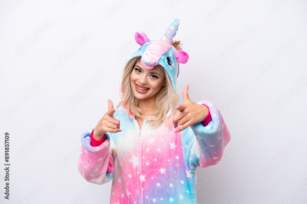 Young Russian woman with unicorn pajamas isolated on white background points finger at you while smiling Young Russian woman with unicorn pajamas isolated on white background points finger at you while smiling