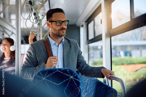 Tableau sur toile Pensive businessman commuting by public transportation.