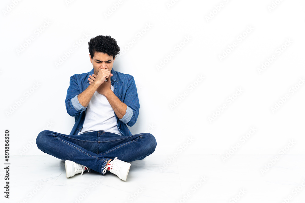 Venezuelan man sitting on the floor is suffering with cough and feeling bad Venezuelan man sitting on the floor is suffering with cough and feeling bad