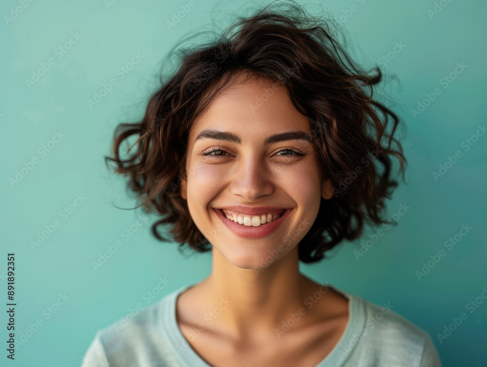 Smiling Woman with Curly Hair against a Blue Background Smiling Woman with Curly Hair against a Blue Background