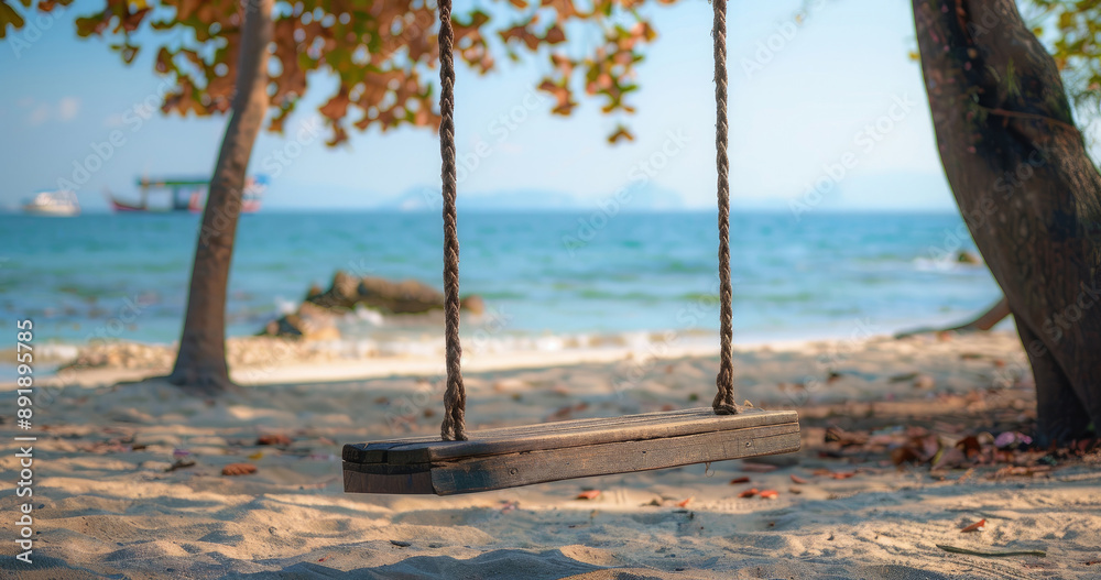 Rustic wooden swing hanging from tree, overlooking tranquil beach and clear blue sea Rustic wooden swing hanging from tree, overlooking tranquil beach and clear blue sea