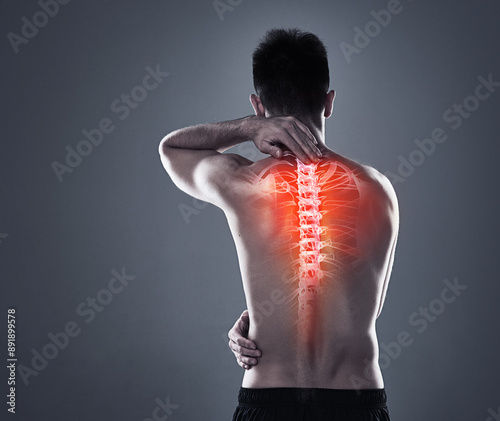 Man, injury and back pain of fitness in studio, anatomy of spine and xray for diagnosis. Red glow, mockup and rear view of person for inflammation of muscle ache, spinal stenosis and gray background. photo