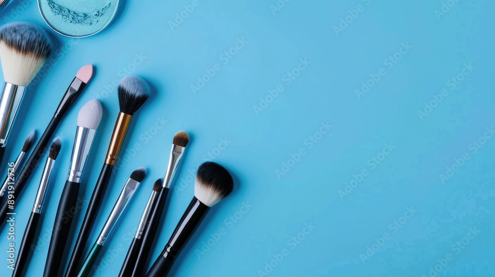 Professional cosmetics and makeup tools on a blue background beauty and fashion concept Professional cosmetics and makeup tools on a blue background beauty and fashion concept
