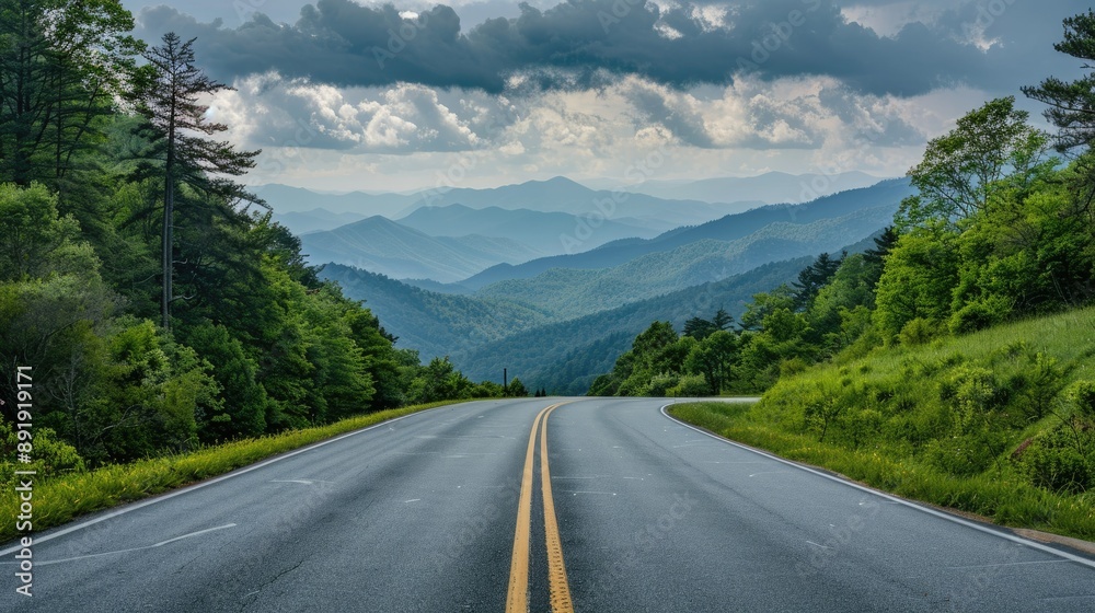 Fototapeta premium Expansive road heading towards the Great Smoky Mountains National Park, Tennessee, surrounded by lush landscapes and distant peaks