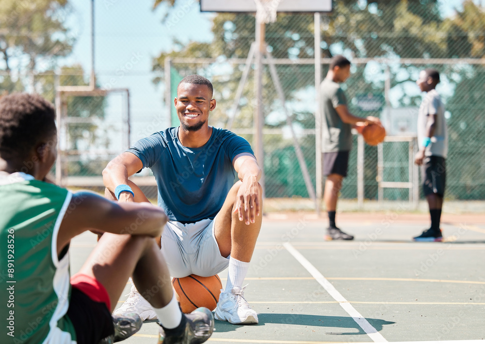 Basketball, team sports and social conversation at the court for break after fitness, training or exercise match. Happy basketball players talking, discussion or relaxing on the basketball court Basketball, team sports and social conversation at the court for break after fitness, training or exercise match. Happy basketball players talking, discussion or relaxing on the basketball court