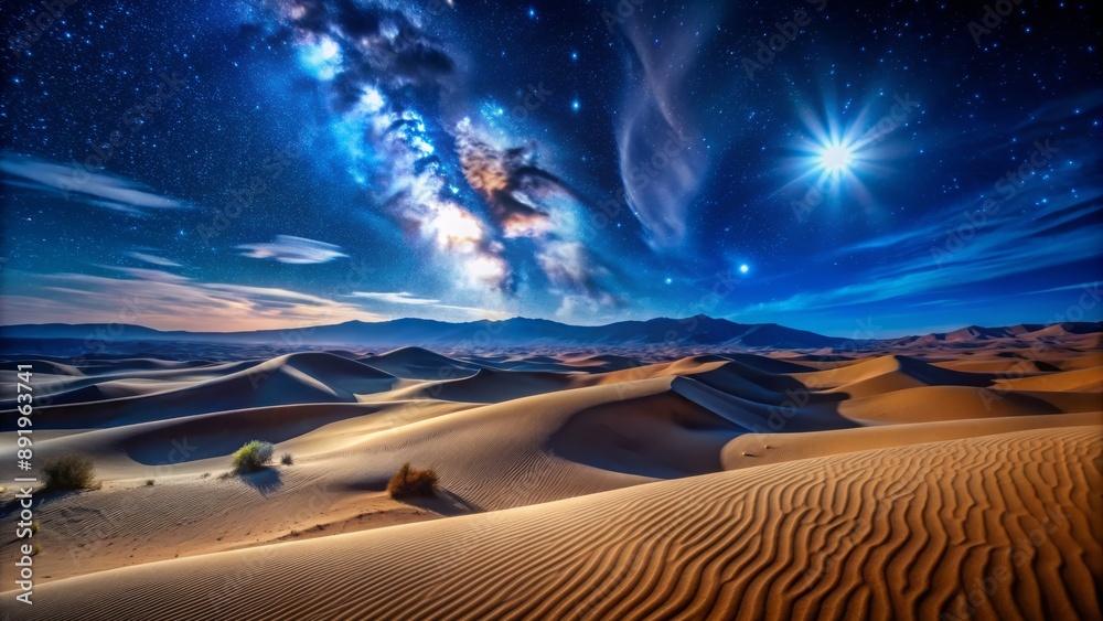 Naklejka premium Dark blue starry night sky above vast expanse of rolling sand dunes, illuminated by soft moonlight, casting long shadows.