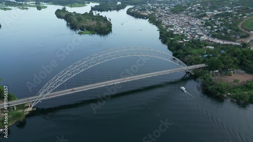 Drone shot of Boat cruise under the Adomi Bridge in Akosombo, Ghana photo