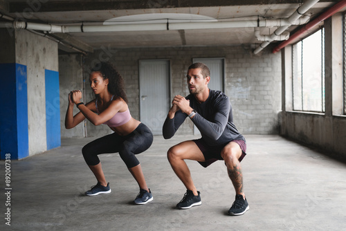 Couple, fitness and squat for exercise outdoor, muscle development and balance support of training goal. Woman, man and workout progress, bodybuilder and cardio resilience of wellness performance