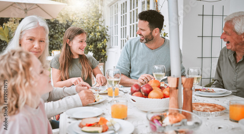 Family, food and eating lunch outdoor for holiday celebration, brunch and bonding with conversation. Relatives, people and dinner event on patio in festive season at home, healthy meal and happy