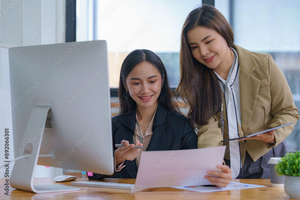 Two Young Asian businesswomen discuss a new startup project Idea presentation and analyze planning, financial statistics, and investment market at the office. Two Young Asian businesswomen discuss a new startup project Idea presentation and analyze planning, financial statistics, and investment market at the office.