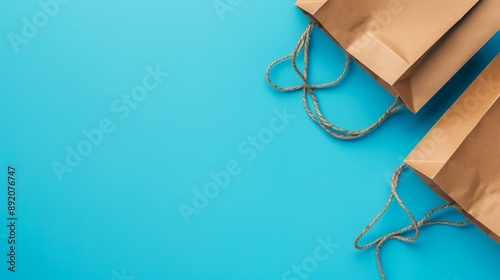 Minimalistic flat lay of ecofriendly shopping paper bags isolated on background with text space, black textile cotton bags for recycle shopping bag