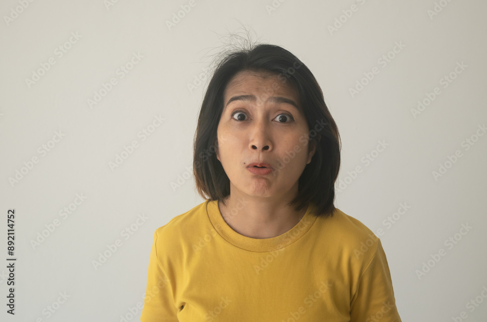 Asian woman standing shocked face Isolated over grey background surprised and wearing shirt orange Asian woman standing shocked face Isolated over grey background surprised and wearing shirt orange