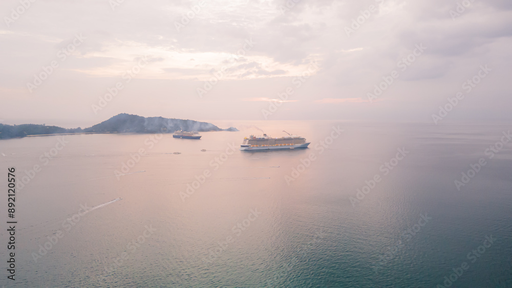 Obraz premium Aerial view, drone flying over Phuket city, Thailand. Drone over Patong Beach on Sunday in Phuket and tourists shopping at a street full of local merchants selling food, people resting by the sea.