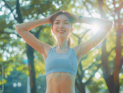 Female jogger. Fit young Asian woman with blue sportswear stretching muscle in park before running and enjoying a healthy outdoor. Fitness runner girl in public park. Wellness being concept