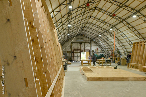 Wood wooden modular houses made of timber yellow board saw processing hands nail grind