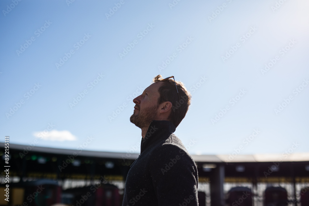 Fototapeta premium caucasian man blue sky looking up wishing hoping contemplating 