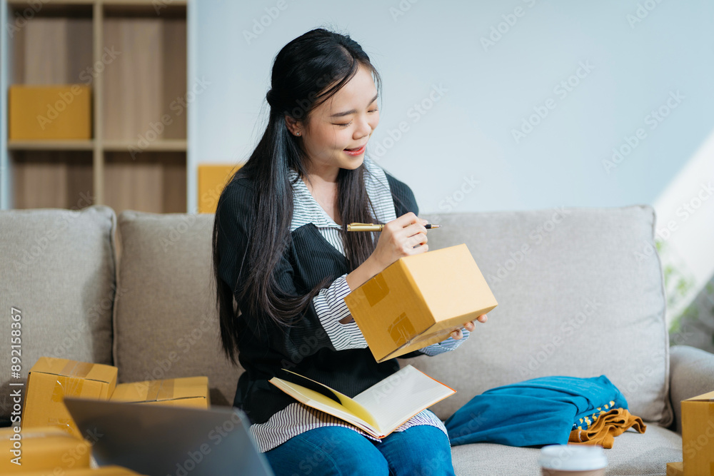 Woman start up online seller owner at workplace. small business entrepreneur SME or freelance asian woman working with box at home. Woman start up online seller owner at workplace. small business entrepreneur SME or freelance asian woman working with box at home.