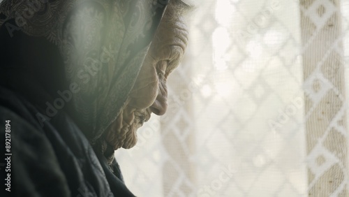 Poor old grandmother takes eggs at the window