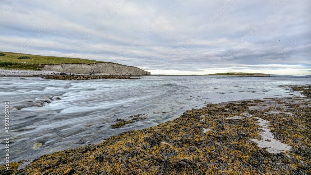 Dramatic coastal sunset landscape scenery with cliffs in background, sandy Silverstrand beach, Galway, Ireland, nature wallpaper