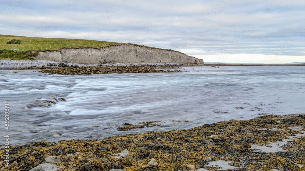 Dramatic coastal sunset landscape scenery with cliffs in background, sandy Silverstrand beach, Galway, Ireland, nature wallpaper