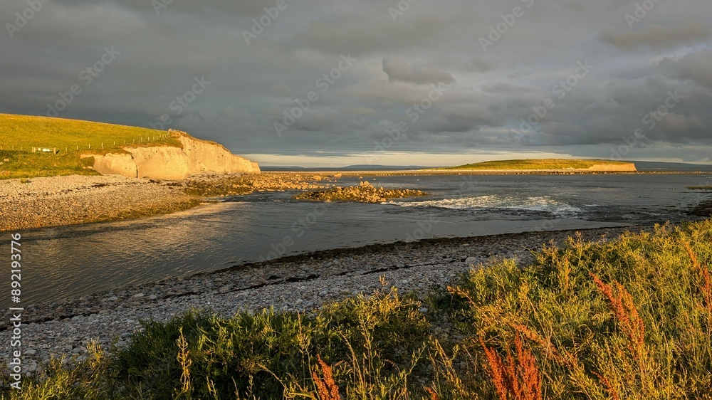 Dramatic coastal sunset landscape scenery with cliffs in background, sandy Silverstrand beach, Galway, Ireland, nature wallpaper