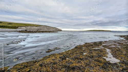 Dramatic coastal sunset landscape scenery with cliffs in background, sandy Silverstrand beach, Galway, Ireland, nature wallpaper photo