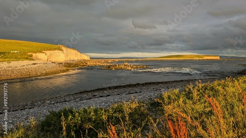 Obraz na płótnie Dramatic coastal sunset landscape scenery with cliffs in background, sandy Silverstrand beach, Galway, Ireland, nature wallpaper w salonie